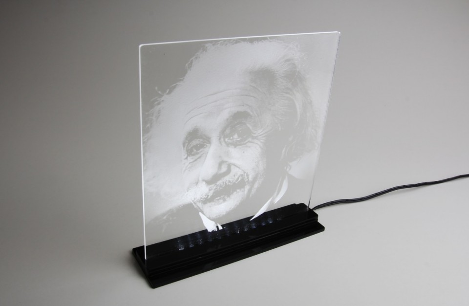 Laser rastering of an image on to an acrylic plate illuminated with LED lighting