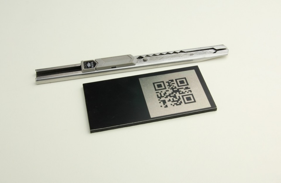QR code laser engraved over a plate of painted aluminum