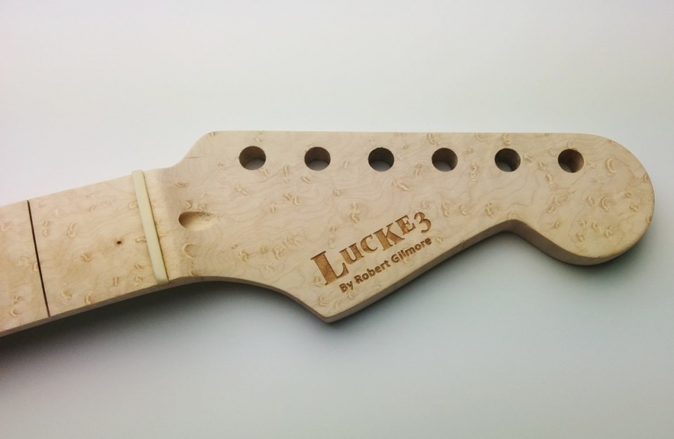 Laser Engraving of a logo on wood - personal laser marking on a guitar