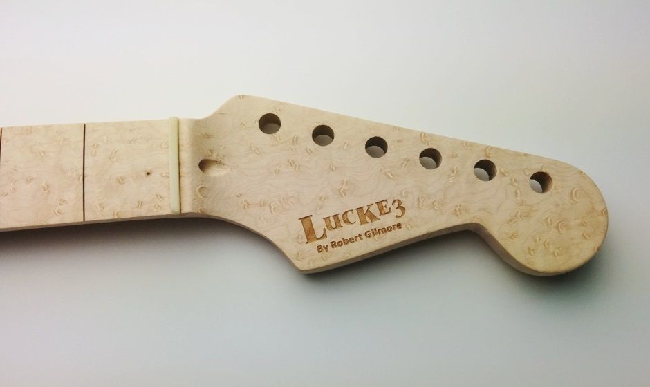Laser engraving on maple wood - a logo added to a guitar bridge for branding manners