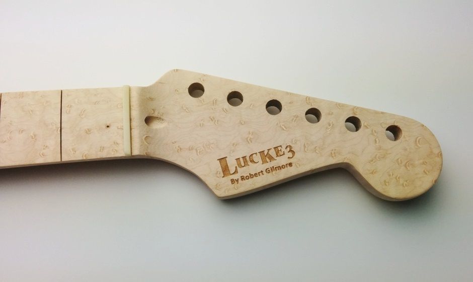 custom branding using Laser engraving of a logo on a guitar bridge